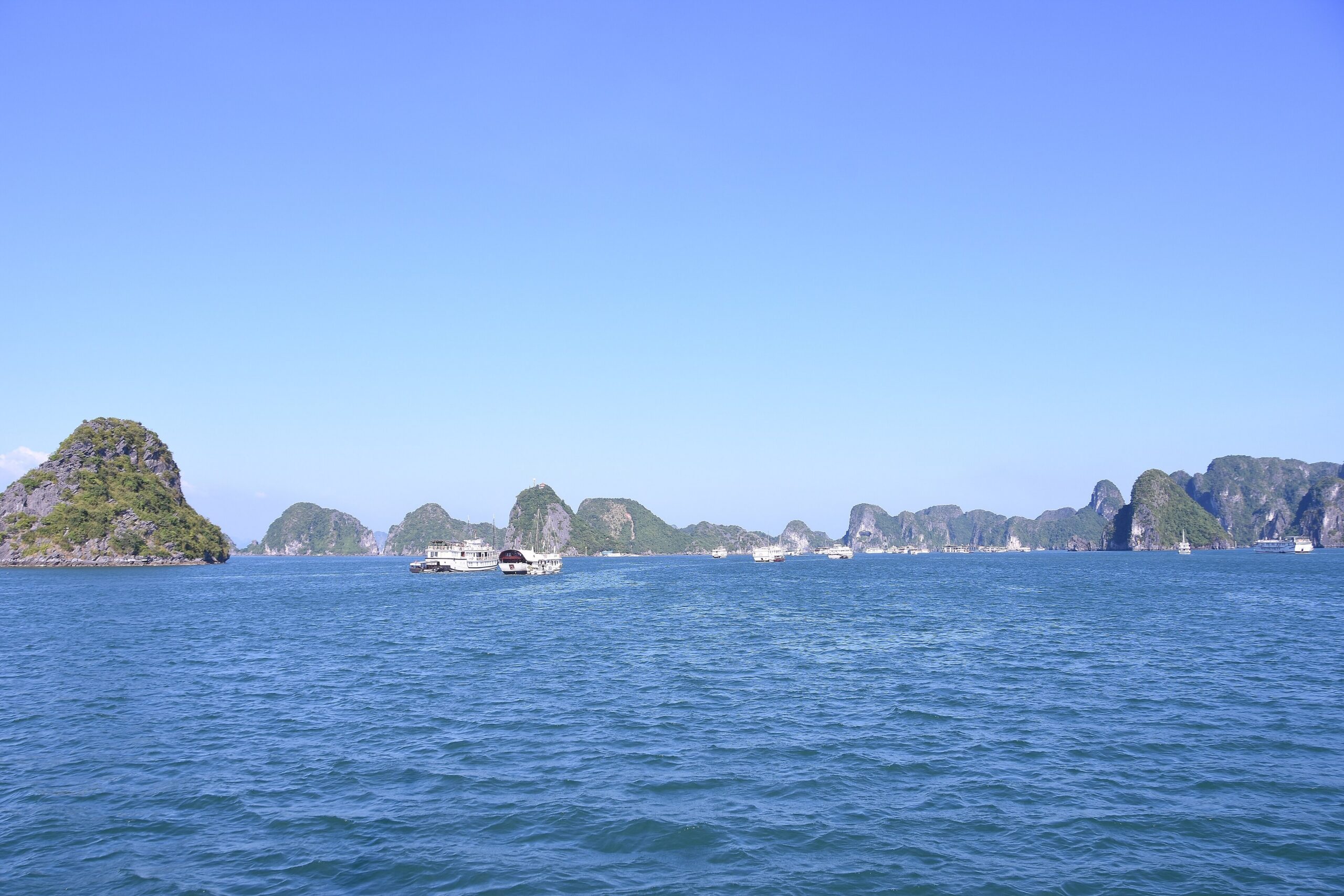Limestone karst islands rising from the water in Ha Long Bay